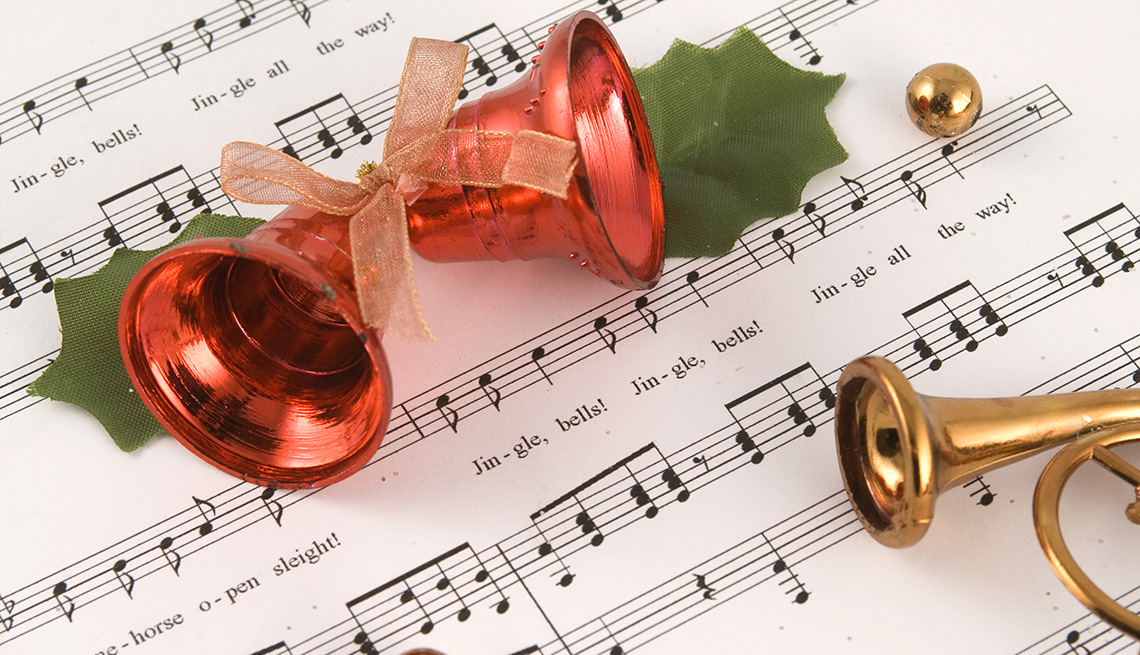Bells on top of sheet music for the song Jingle Bells