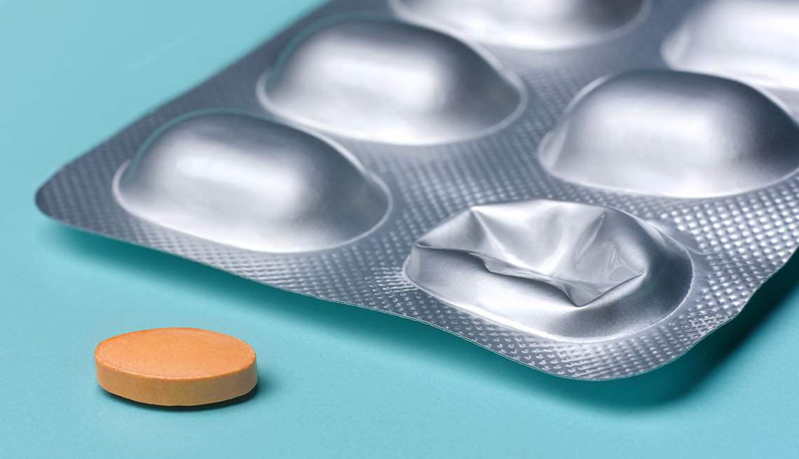 pill removed from blister pack ready to take