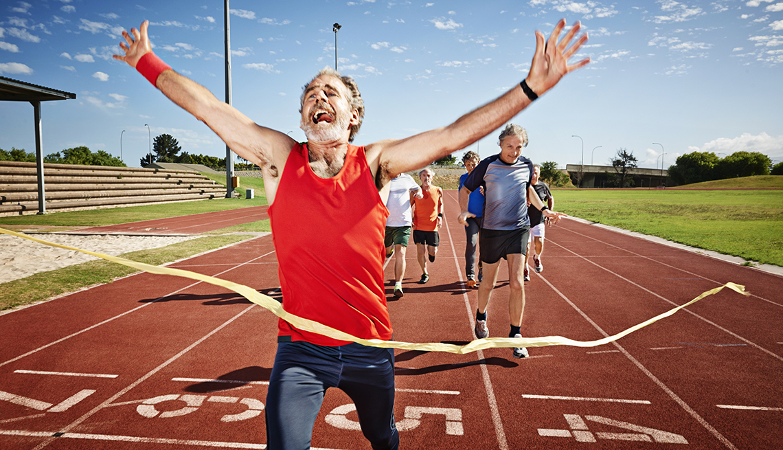 man crossing finish line