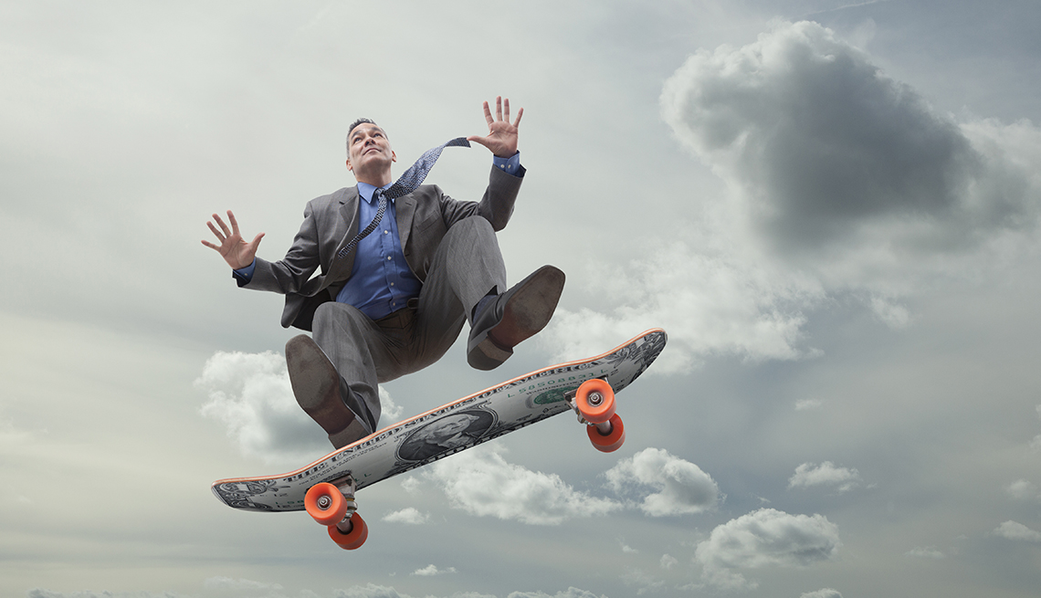 Businessman airborne on skateboard