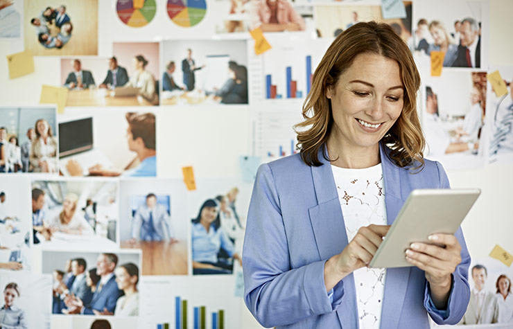 Businesswoman looking at digital tablet, The Basics of Starting Your Own Business