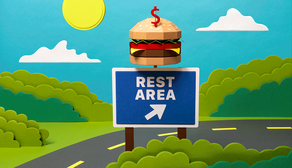 Animación  de una autopista con un aviso de una zona de descanso con una hamburguesa encima