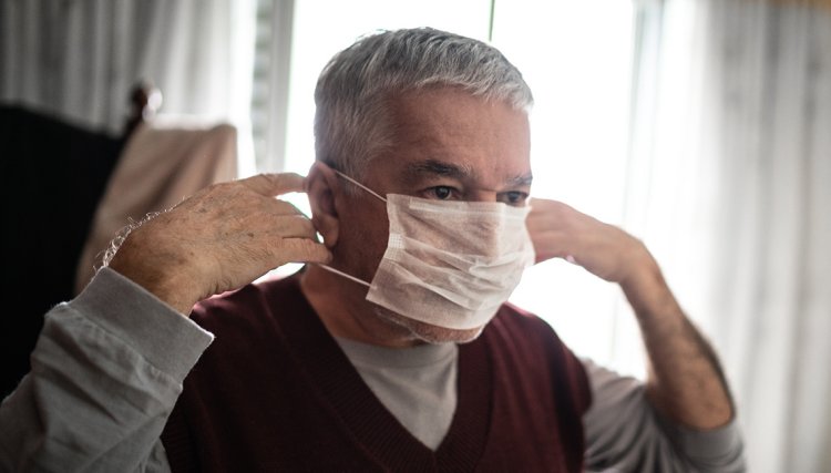Un hombre se pone un tapabocas